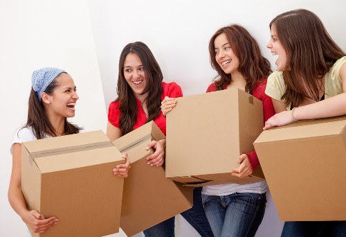 Professional movers handling boxes and furniture during a Kentish Town home move