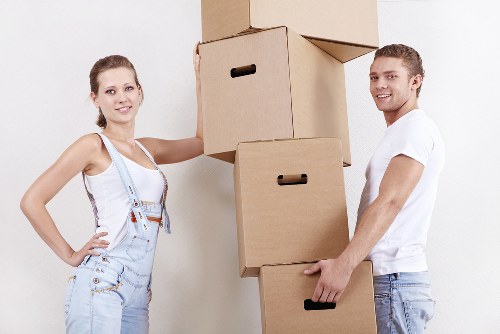 Local movers carrying boxes near Kentish Town streets
